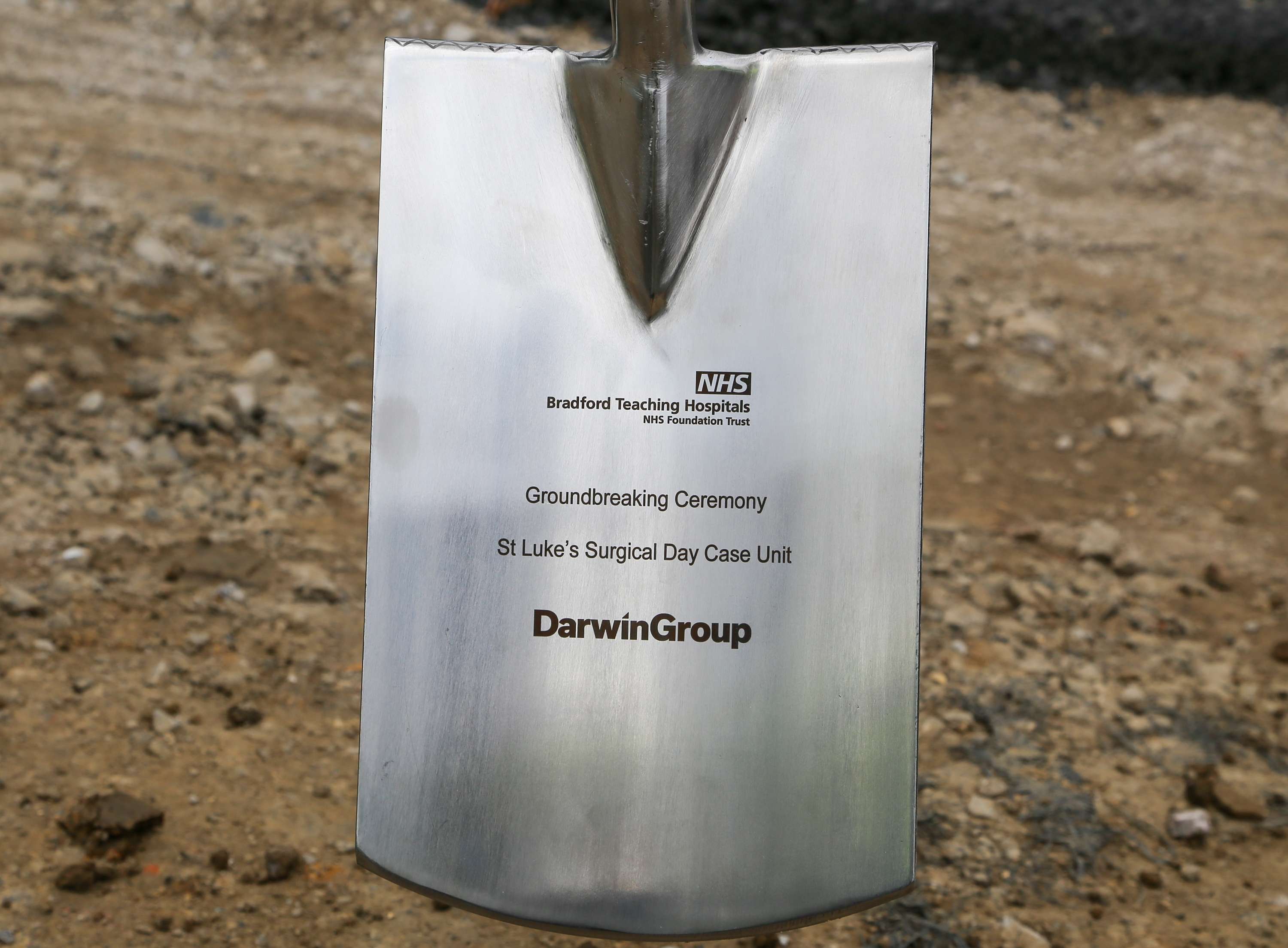 Close up image of the engraved ceremonial spade from the St Luke's ground breaking ceremony.