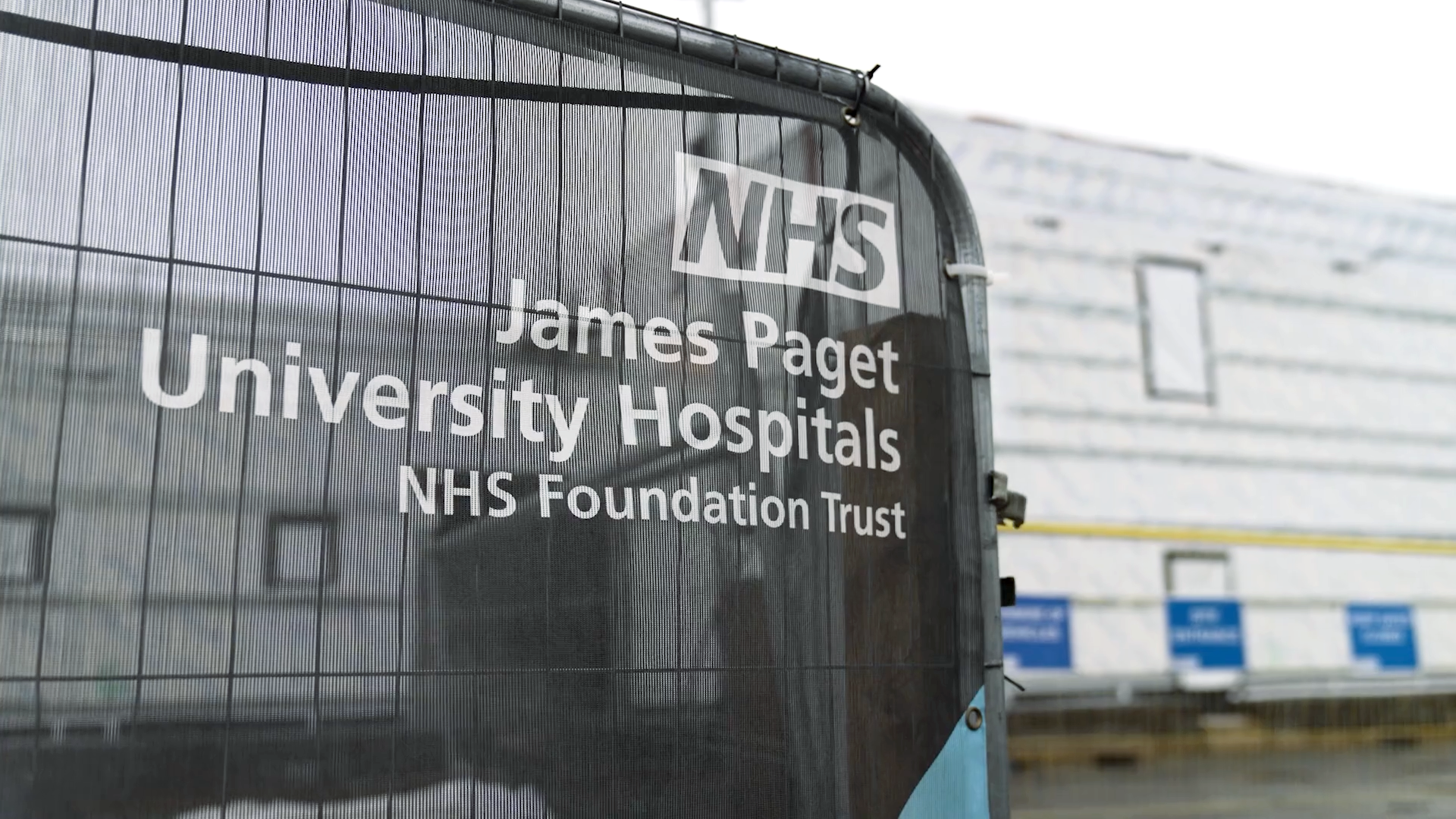 A picture of a fence with the James Paget hospital sign on